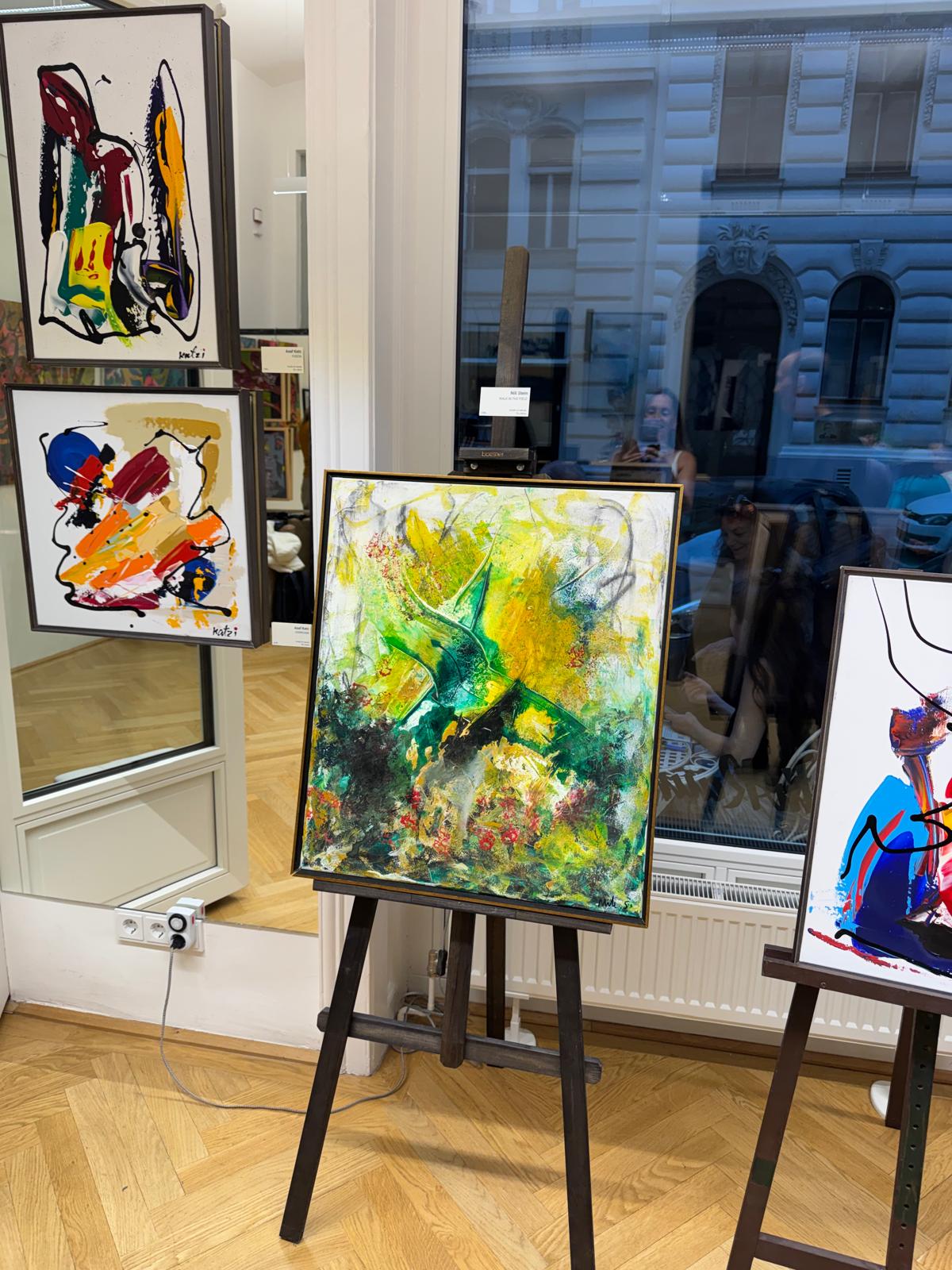 Exhibition space in Vienna with the painting displayed on an easel